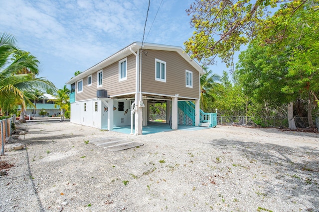 22878 Privateer Dr, Cudjoe, FL 33042 - view of property exterior featuring a carport, stairway, and driveway