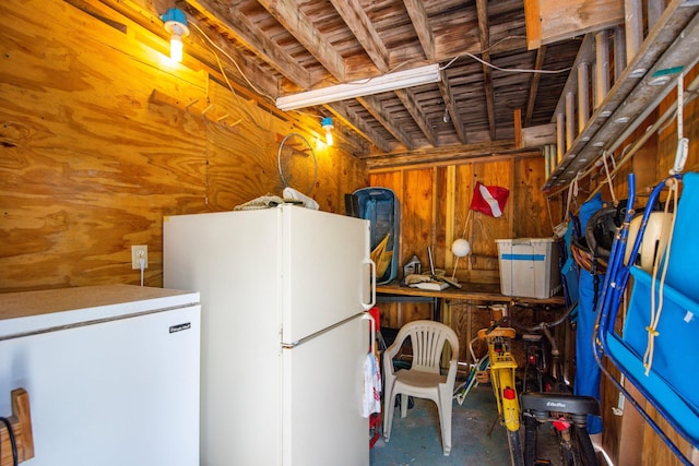 22878 Privateer Dr, Cudjoe, FL 33042 - below grade area with freestanding refrigerator, white refrigerator, and wooden walls