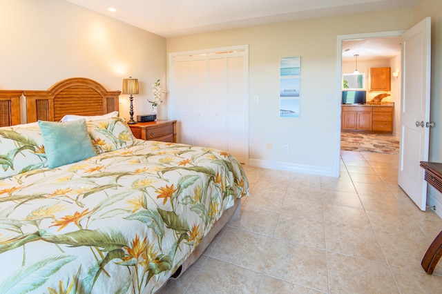 bedroom with a closet, baseboards, recessed lighting, and light tile patterned floors