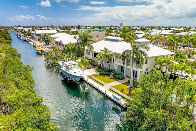 birds eye view of property with a water view and a residential view