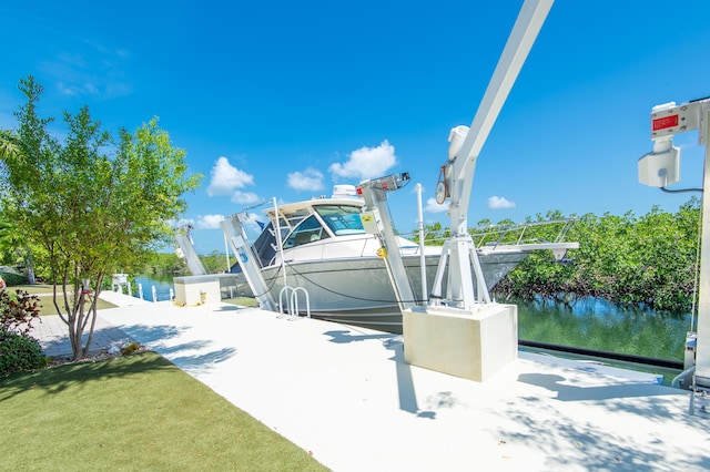 view of property's community featuring a water view, a dock, and boat lift