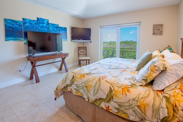 tiled bedroom with access to outside, baseboards, and lofted ceiling