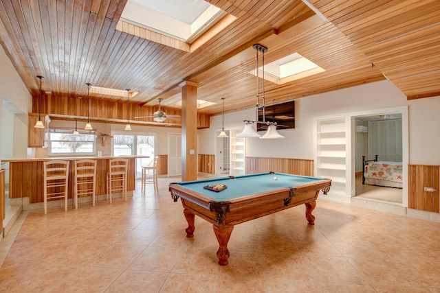 rec room featuring light tile patterned floors, wainscoting, wooden ceiling, and a skylight