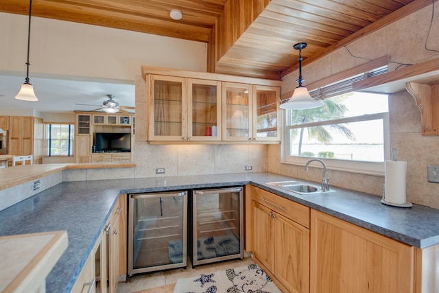 kitchen featuring wine cooler, a sink, and a healthy amount of sunlight