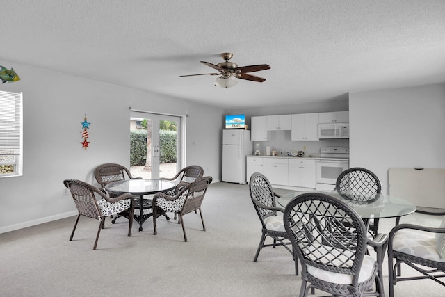 389 Anglers Dr Unit 105, Marathon, FL 33050 - dining space with light carpet, a ceiling fan, and a textured ceiling