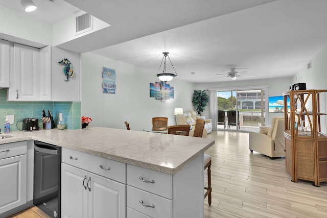 389 Anglers Dr Unit 105, Marathon, FL 33050 - kitchen with a peninsula, dishwasher, white cabinetry, and a ceiling fan