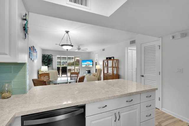 389 Anglers Dr Unit 105, Marathon, FL 33050 - kitchen with stainless steel dishwasher, light countertops, ceiling fan, light wood finished floors, and white cabinets