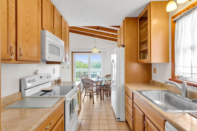 kitchen featuring white appliances, light tile patterned floors, a sink, light countertops, and pendant lighting