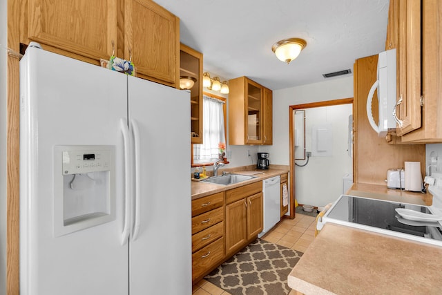 kitchen with visible vents, a sink, white appliances, light countertops, and light tile patterned floors