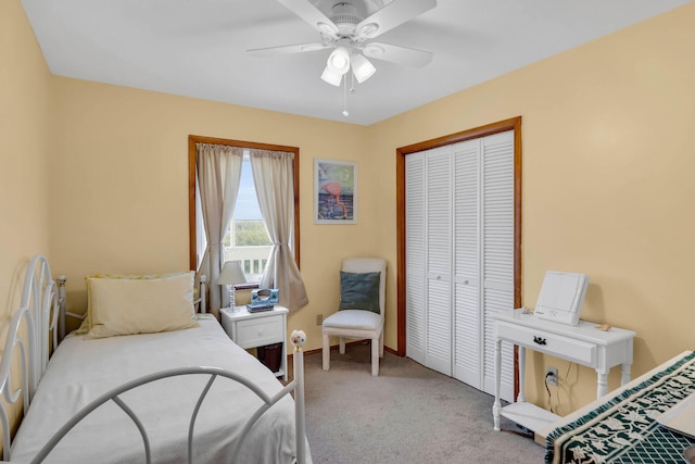 carpeted bedroom featuring a closet, baseboards, and ceiling fan