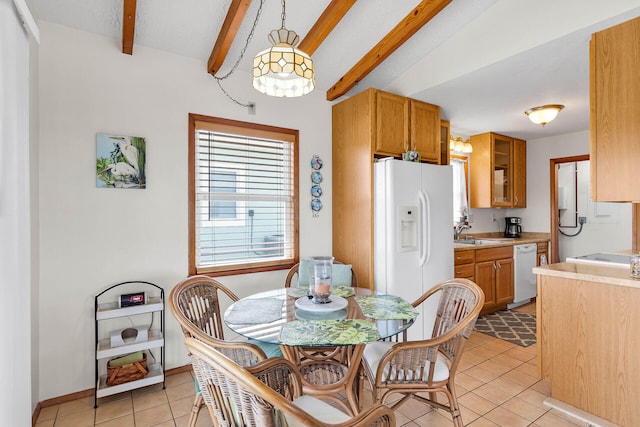 dining area featuring beam ceiling, light tile patterned floors, and baseboards