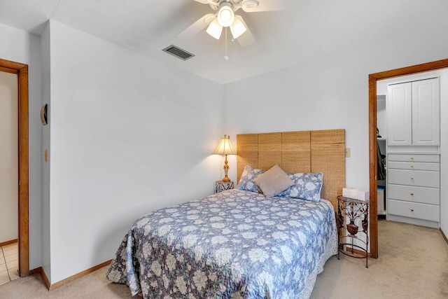 carpeted bedroom featuring a ceiling fan, baseboards, and visible vents