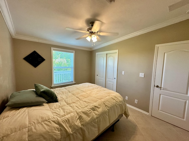 19749 Date Palm Dr, Sugarloaf, FL 33042 - bedroom featuring a closet, crown molding, a ceiling fan, light tile patterned floors, and baseboards