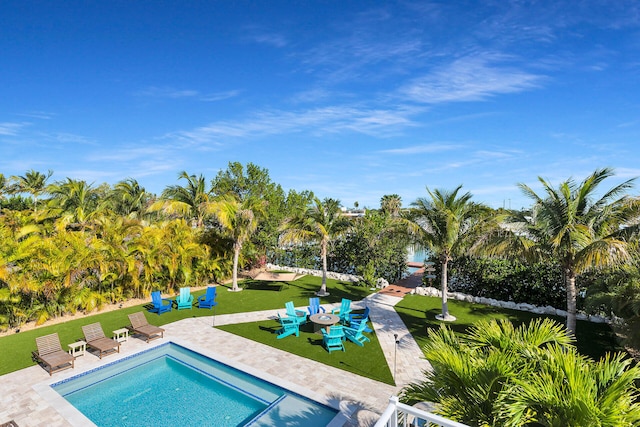 outdoor pool featuring a patio area and a lawn