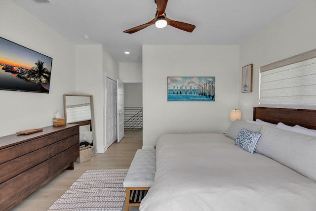 bedroom featuring light wood finished floors, a ceiling fan, and recessed lighting