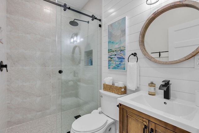 bathroom with toilet, vanity, and a stall shower
