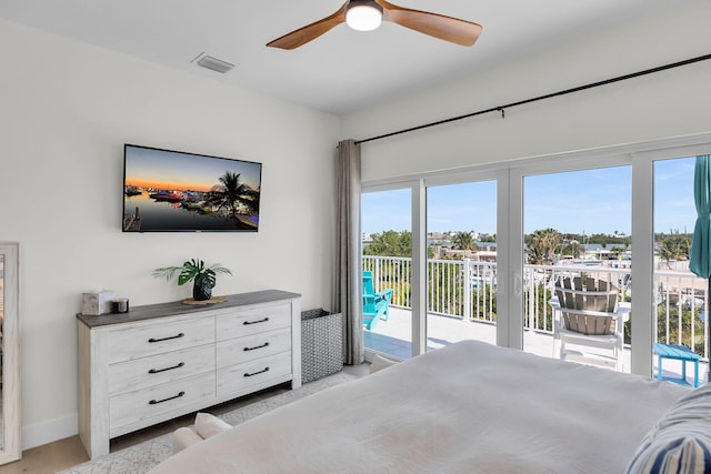 bedroom with access to outside, ceiling fan, multiple windows, and visible vents