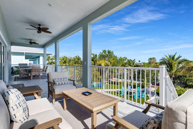 balcony with an outdoor living space, outdoor dining space, and a ceiling fan