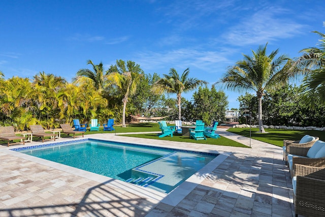 pool featuring a yard and a patio