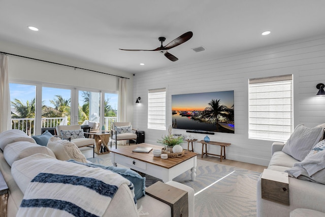 living area featuring visible vents, ceiling fan, recessed lighting, and wood finished floors