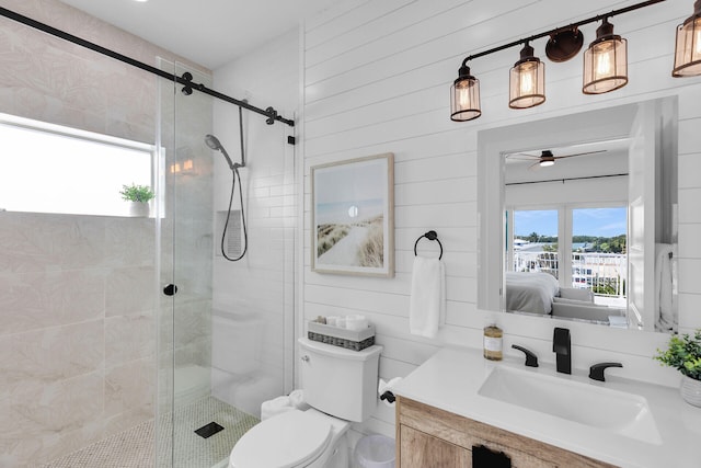 ensuite bathroom featuring toilet, a shower stall, ensuite bath, and a ceiling fan