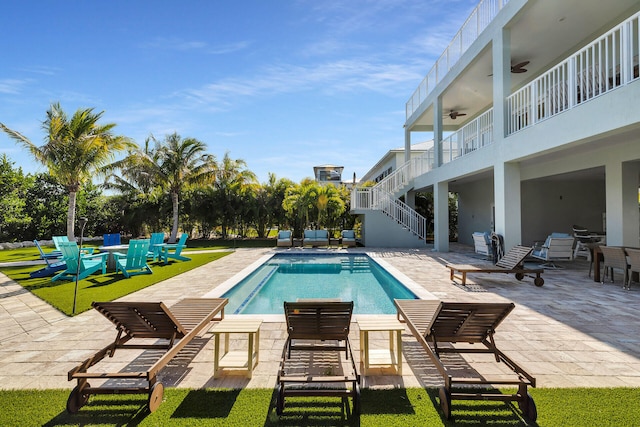 pool with a patio area, stairway, and ceiling fan