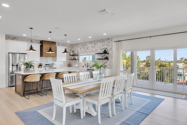 dining room featuring light wood-type flooring, visible vents, and recessed lighting