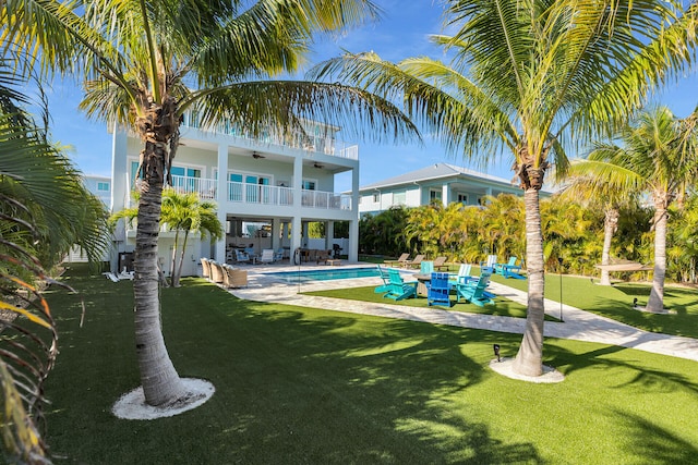 pool featuring a ceiling fan, a patio, and a lawn