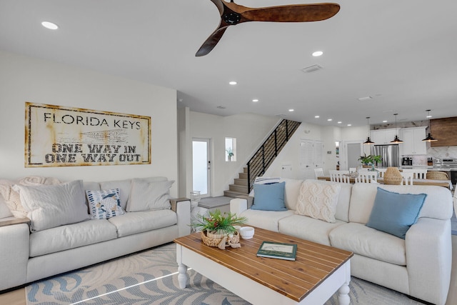 living room with recessed lighting, stairway, visible vents, and a ceiling fan