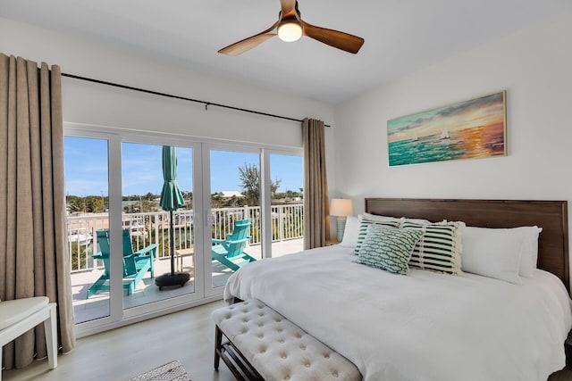 bedroom featuring access to outside, wood finished floors, and a ceiling fan