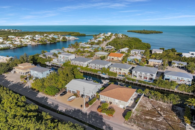 drone / aerial view with a residential view and a water view