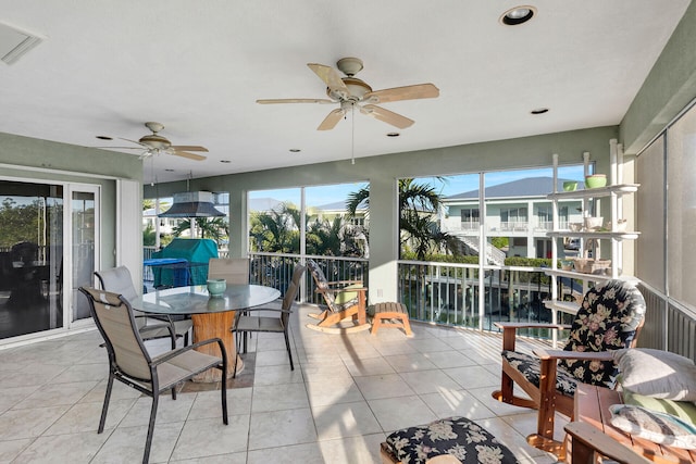 sunroom featuring plenty of natural light, visible vents, and a ceiling fan