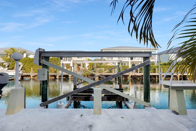 view of dock featuring a water view and boat lift