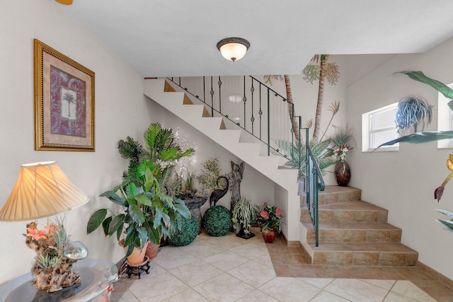 stairway with tile patterned floors