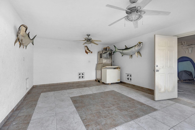 interior space with a ceiling fan, baseboards, and light tile patterned floors