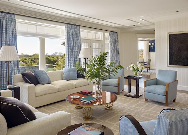 living room featuring light hardwood / wood-style flooring, a healthy amount of sunlight, and ornamental molding