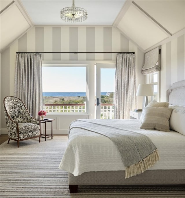 carpeted bedroom featuring a notable chandelier, lofted ceiling, and multiple windows