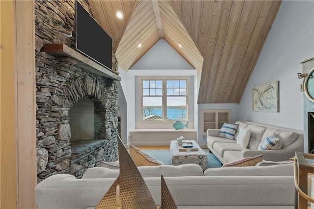 living room with radiator heating unit, high vaulted ceiling, a fireplace, a water view, and wood ceiling