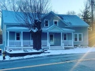 neoclassical home featuring a porch