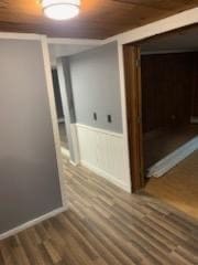 hallway with hardwood / wood-style floors