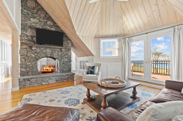 living room featuring a fireplace, wooden ceiling, french doors, and wood-type flooring