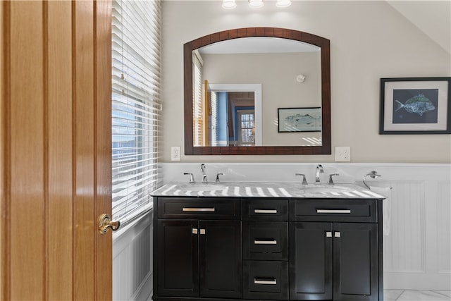 bathroom with vanity and lofted ceiling