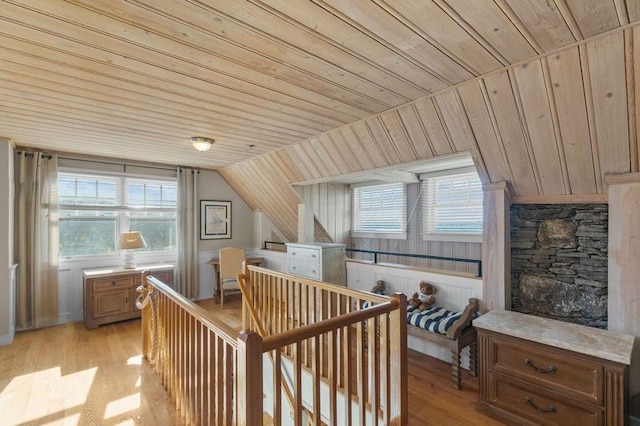 additional living space featuring vaulted ceiling, wood ceiling, and light hardwood / wood-style flooring