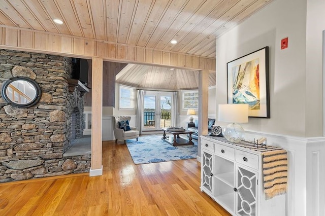 interior space with light hardwood / wood-style flooring and wooden ceiling