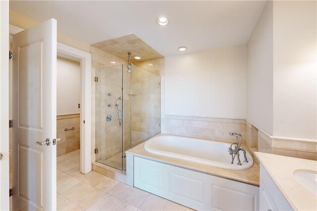 bathroom with tile patterned flooring, vanity, and independent shower and bath