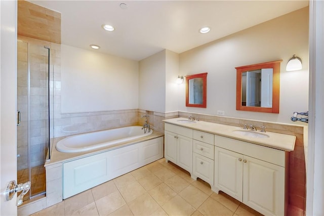 bathroom with tile patterned flooring, vanity, and independent shower and bath