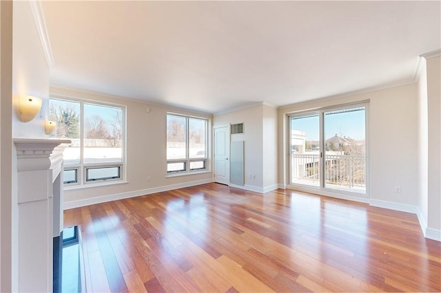 unfurnished living room with light hardwood / wood-style flooring and ornamental molding