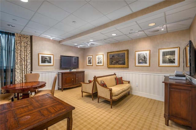 interior space featuring light carpet and a drop ceiling