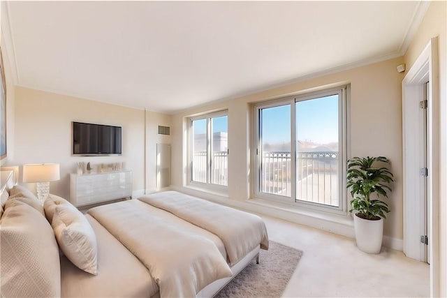 bedroom with light colored carpet and crown molding