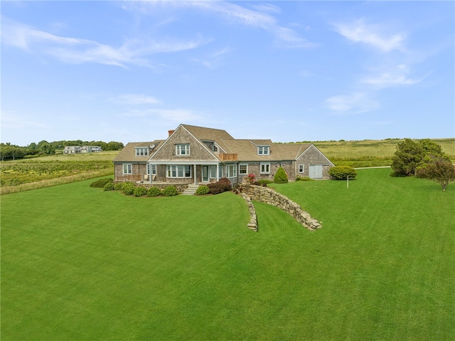 back of property with covered porch and a lawn